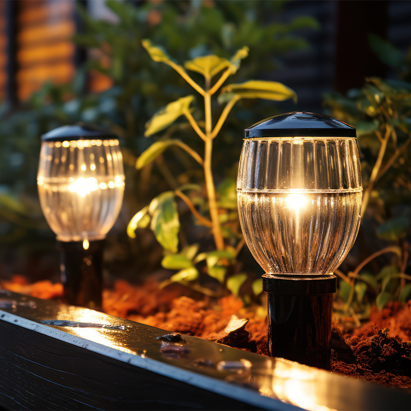 lighting can be used to personalise your small garden fencing ideas. This image shows 2 stake lights in the immediate foreground and the ideal fencing for small gardens in the far background in the left of the image.