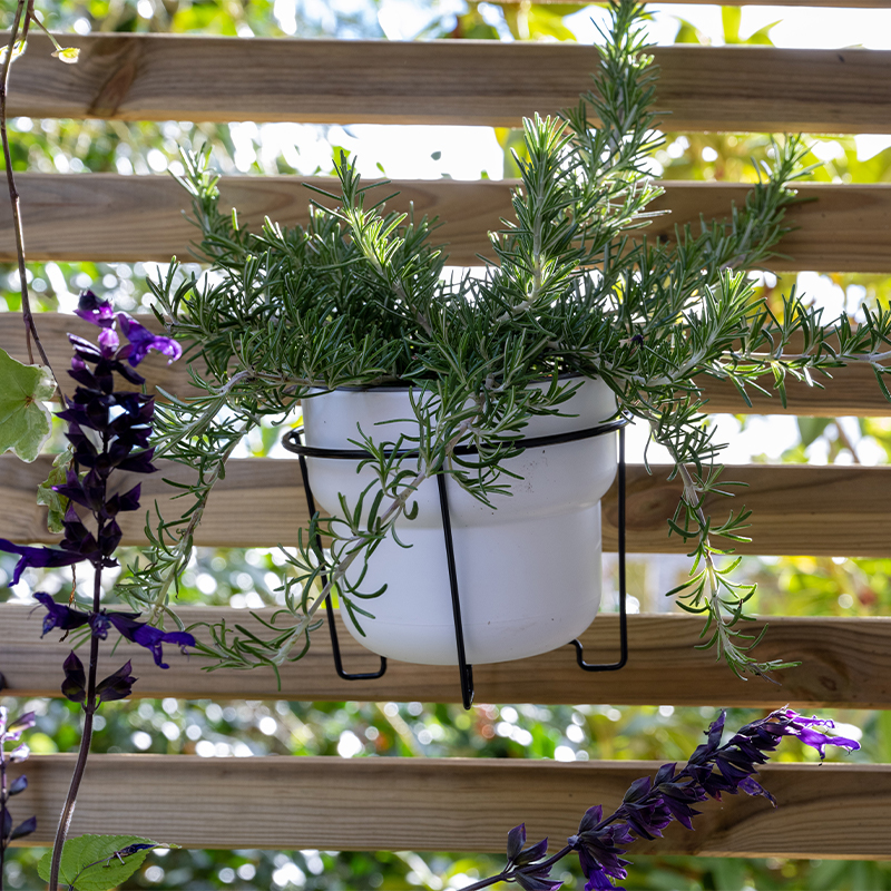 Using fencing to hang planters and plant pots is one of our small garden fencing ideas